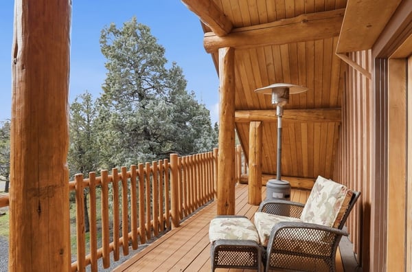 Experience outdoor relaxation on this spacious balcony, surrounded by natural wood accents and tranquil views.