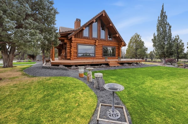 This striking log home features expansive outdoor space, modern amenities, and stunning views in a tranquil setting.