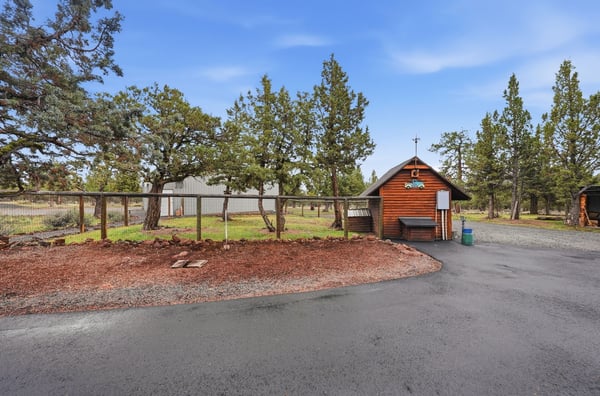 Cozy cabin retreat surrounded by nature, featuring ample outdoor space and a convenient access road.