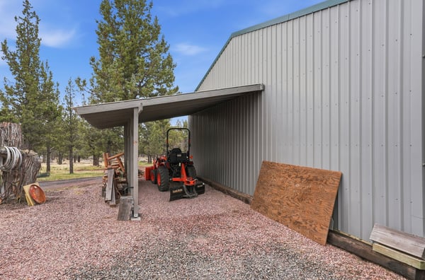 Spacious property featuring a covered area for equipment and ample space for outdoor projects.