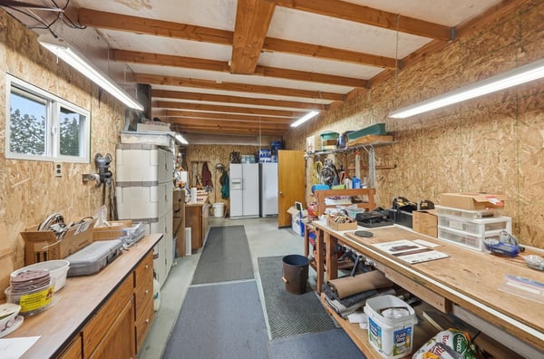 The heated workshop with built-in workbenches and storage has bright lighting for all your projects.