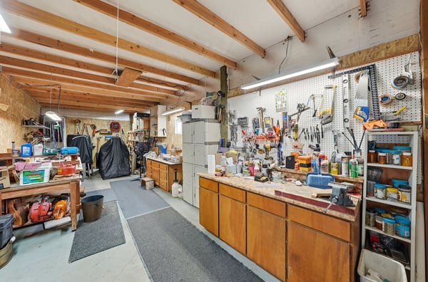 Expansive workshop featuring ample storage, well-equipped tool storage, and versatile workspace for projects and hobbies.