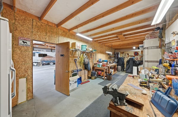 Spacious workshop with ample storage, perfect for hobbies, projects, or potential business ventures.