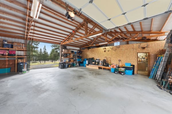 Spacious garage featuring ample storage options and natural light, perfect for hobbies or vehicle maintenance.