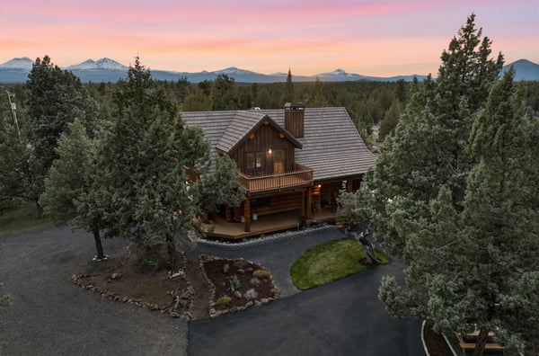 This expansive log cabin features mountain views, private outdoor space, and convenient access to roads leading to town.