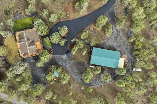 Spacious property with multiple buildings and ample landscaping, offering privacy and versatile outdoor spaces.