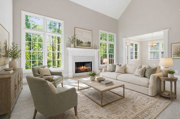 Bright and inviting living room featuring large windows, a cozy fireplace, and modern furnishings for comfort. (Virtual Staging)