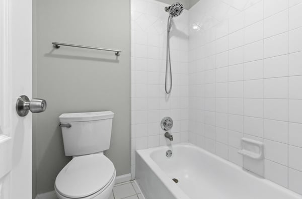 Full guest bathroom with double sinks, separate bathtub and water closet