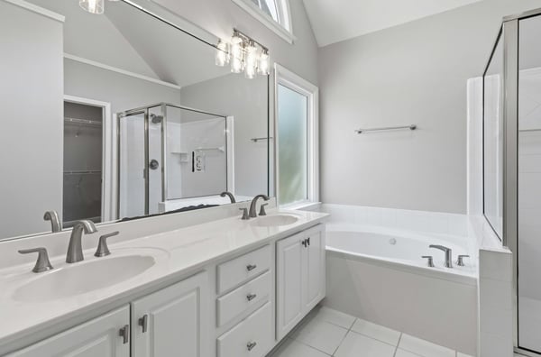 Spacious master bathroom with updated lighting and fixtures