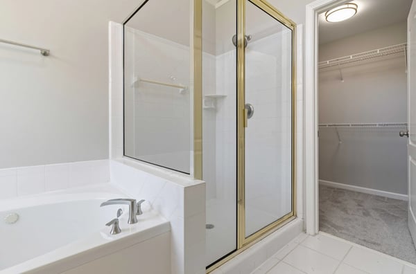 Spacious master bathroom with separate shower and bathtub. Large walk-in closet.