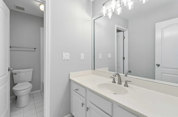 Full guest bathroom with double sinks, separate bathtub and water closet