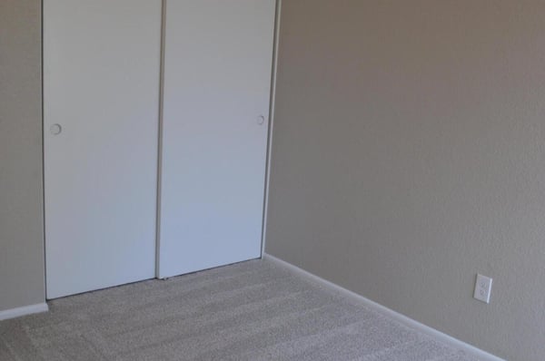 Inviting bedroom with fresh carpeting, ample closet storage, neutral paint, and a ceiling fan. This move-in-ready room offers comfort and versatility for a variety of lifestyles.