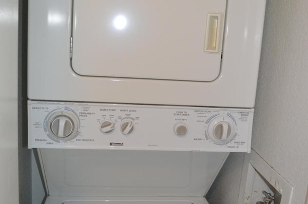 Dedicated laundry closet with stacked washer and dryer offers added convenience and efficient use of space. An everyday feature that enhances the comfort of this move-in-ready Phoenix property.