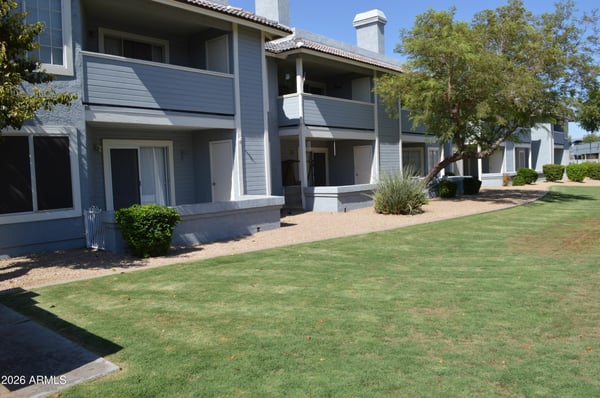 Attractive community grounds featuring lush green lawns, mature trees, and professionally maintained landscaping. The inviting outdoor setting adds to the appeal and lifestyle of this Phoenix home.