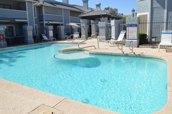 Expansive community swimming pool with shallow entry, surrounding sundeck, and comfortable poolside seating. This impressive amenity adds everyday convenience and enjoyment to life in this desirable Phoenix community.