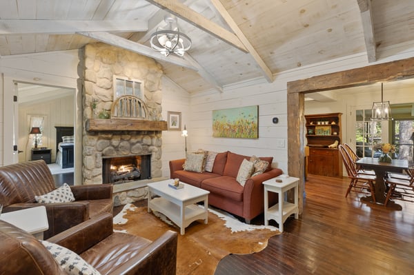 This inviting living space features a stunning stone fireplace and rustic wood accents, perfect for cozy gatherings.