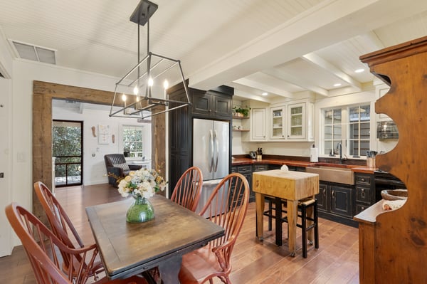 Bright and spacious kitchen featuring modern appliances, inviting dining space, and abundant natural light throughout.