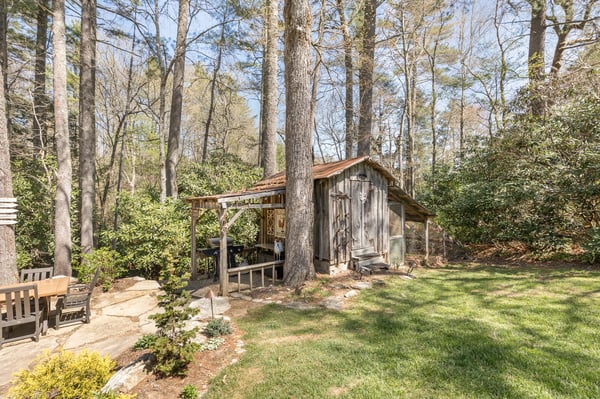 Nestled among tall trees, this unique cabin offers a tranquil retreat with ample outdoor space.