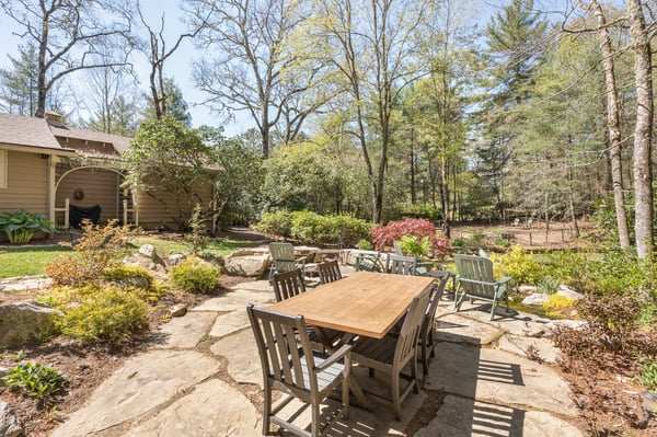 Discover a tranquil outdoor space surrounded by trees, perfect for gatherings and enjoying nature's beauty.