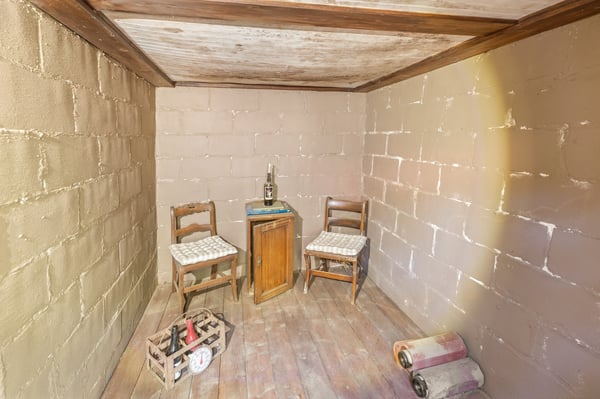 Cozy, secluded space featuring two chairs and a table, perfect for intimate gatherings or creative projects.