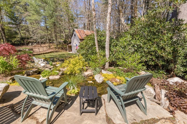 Enjoy peaceful moments by the pond, surrounded by lush greenery and natural beauty in a private setting.