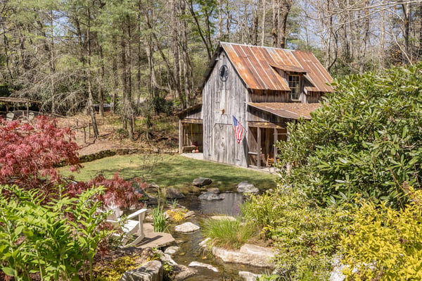 Quaint rustic retreat featuring a tranquil garden, pond, and rustic charm, perfect for peaceful living.