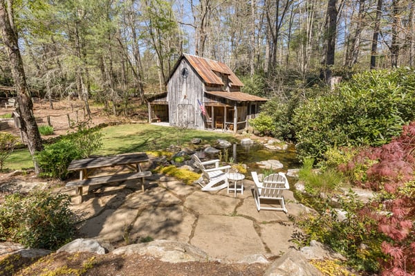 Discover a unique retreat surrounded by nature, featuring a rustic cabin and inviting outdoor seating areas.