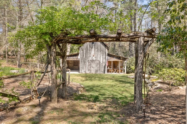 Discover a unique rustic retreat surrounded by nature, featuring a cozy cabin and lush greenery.