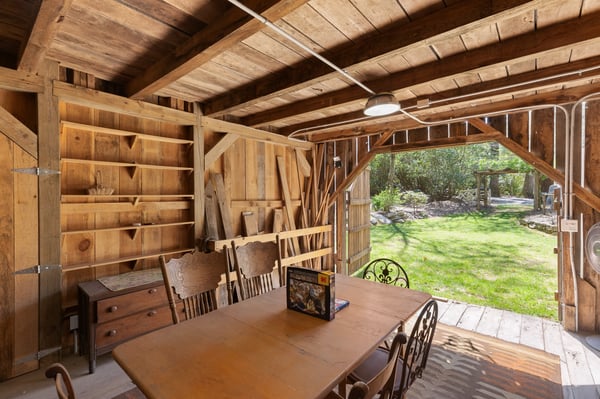 Discover this rustic indoor-outdoor space, perfect for gatherings or creative projects amidst natural surroundings.