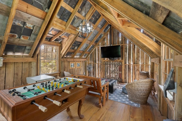 Cozy, rustic retreat featuring a foosball table and panoramic views in a unique lofted space.
