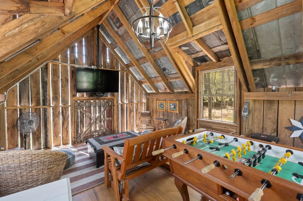 Cozy cabin retreat featuring a foosball table and warm wood accents, perfect for relaxation and entertainment.