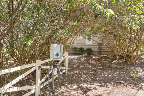 Nestled under lush foliage, this inviting property features a unique design and a private entrance.