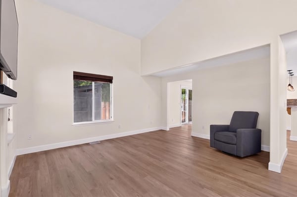 Bright, expansive living area featuring high ceilings and direct access to outdoor spaces, perfect for entertaining.
