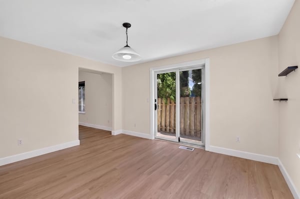 Bright and open living space with ample natural light and direct access to a private outdoor area.