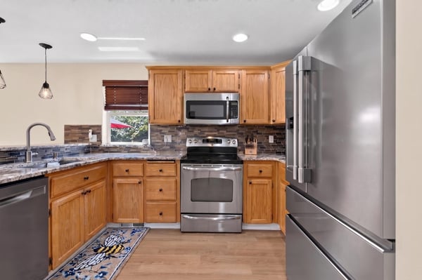 This modern kitchen features sleek appliances, ample cabinetry, and a bright atmosphere perfect for cooking and entertaining.