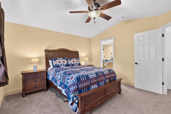 Cozy bedroom featuring a comfortable bed, warm lighting, and a spacious layout with an inviting atmosphere.