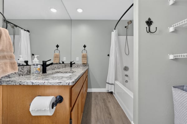 Bright and functional bathroom featuring a spacious vanity, modern fixtures, and convenient storage options.