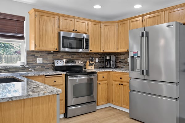 Modern kitchen featuring sleek stainless steel appliances and abundant counter space, ideal for cooking and entertaining.