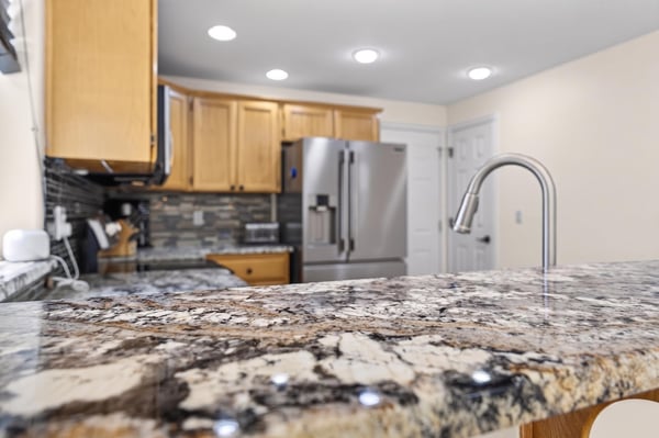 Modern kitchen featuring granite countertops, stainless steel appliances, and ample storage for culinary enthusiasts.