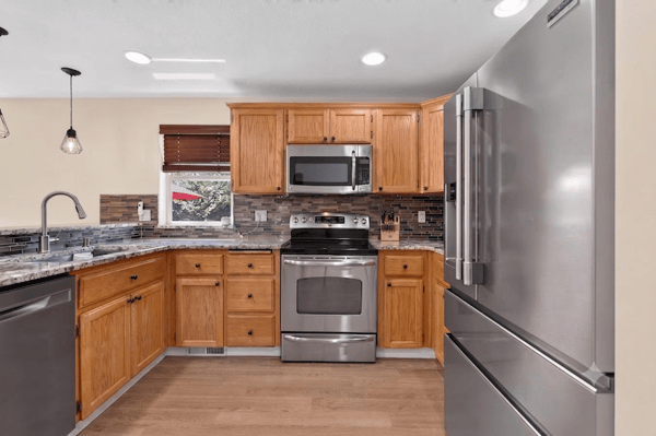 This modern kitchen features stainless steel appliances, ample cabinetry, and a functional layout for easy cooking.