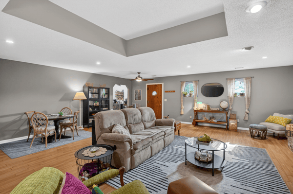 Spacious living area features modern decor, ample natural light, and versatile seating for relaxation or gatherings.