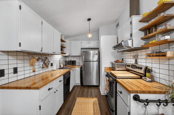 Modern kitchen featuring sleek cabinetry, butcher block countertops, and ample storage for all your culinary needs.