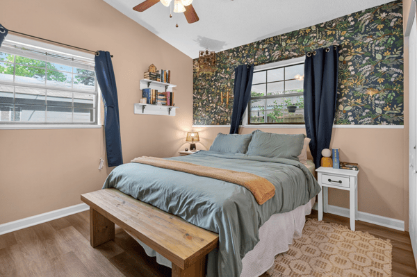 Cozy primary bedroom with ample natural light, perfect for relaxation.
