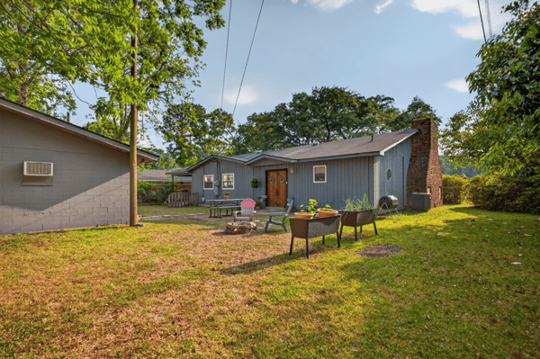 Discover a spacious backyard perfect for gatherings, featuring ample space and unique landscaping opportunities.