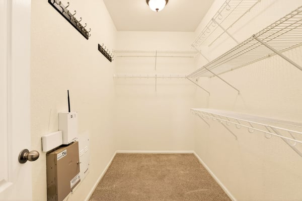 Spacious walk-in closet featuring ample shelving and organizational options for your clothing and accessories.