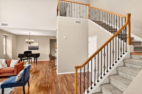 Spacious foyer welcomes you to a bright living area and an inviting staircase to the upper floors.