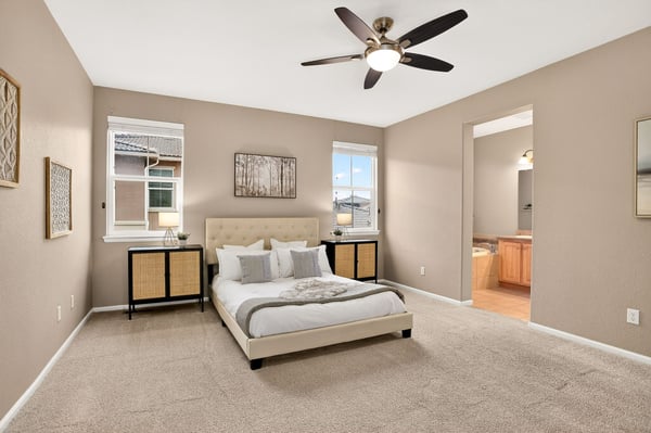 Spacious bedroom with natural light, featuring a comfortable bed and an en-suite bathroom for convenience.