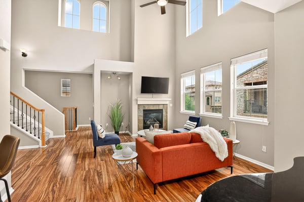Spacious living area features large windows, modern fireplace, and an inviting layout perfect for gathering.