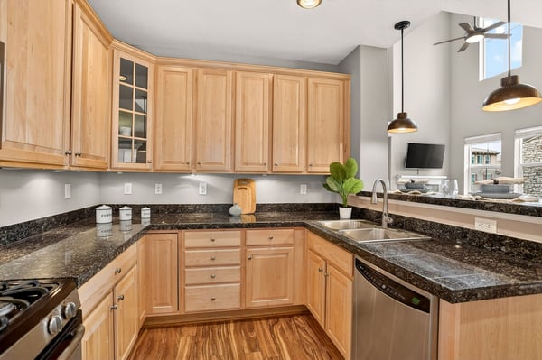 Bright and spacious kitchen featuring modern appliances, ample cabinetry, and stylish granite countertops for culinary enthusiasts.