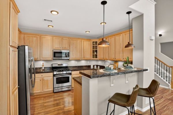 Modern kitchen featuring sleek stainless steel appliances, granite countertops, and a convenient breakfast bar.